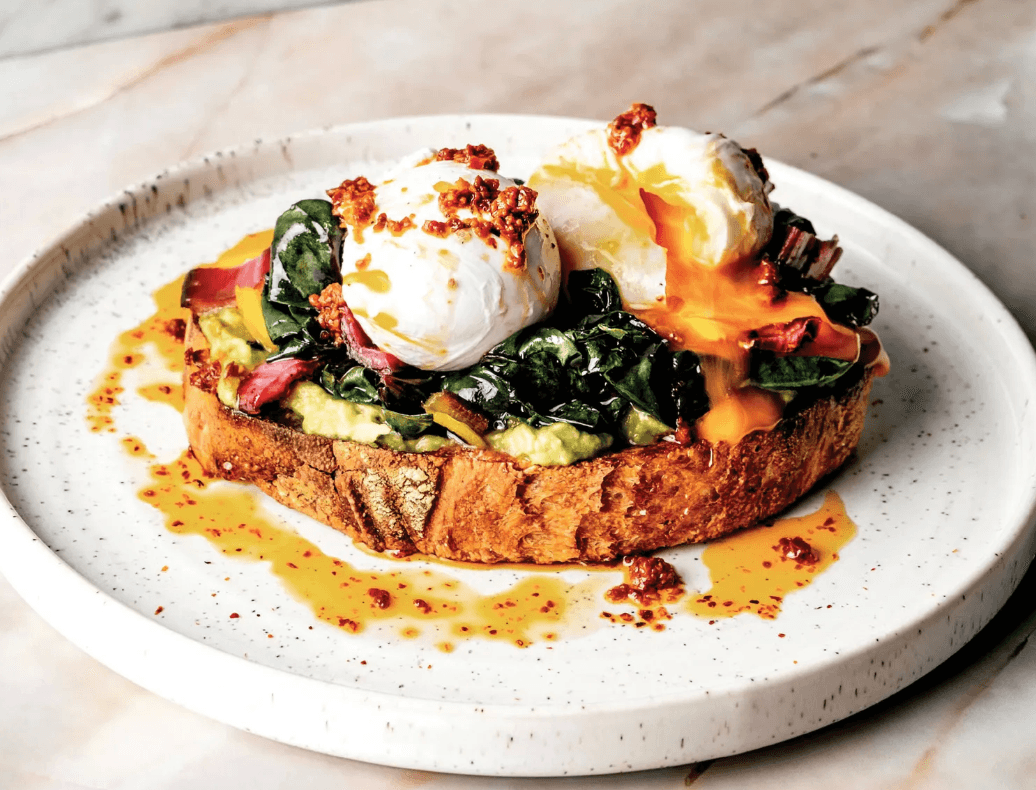 Harissa Eggs with poached eggs, greens and chilli oil
