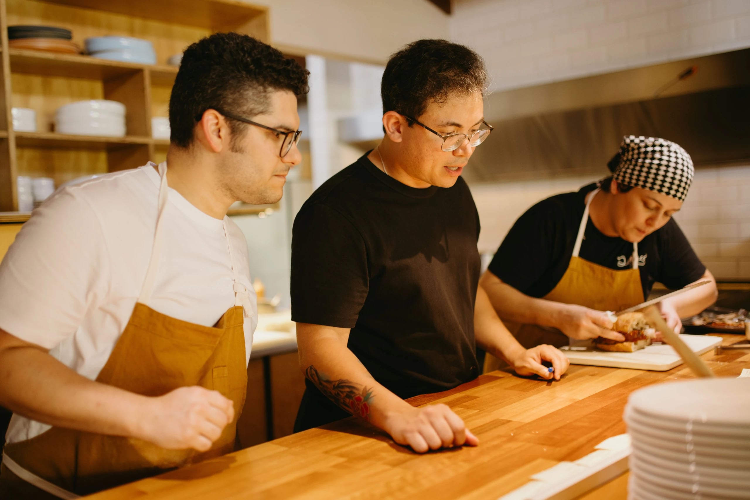Hospitality team planning food preparation together in a kitchen